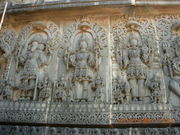Temple carving at Hoysaleswara temple representing the Trimurti: Brahma, Shiva and Vishnu.