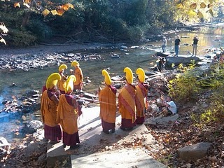 Monks carrying sand to final place, a nearby river