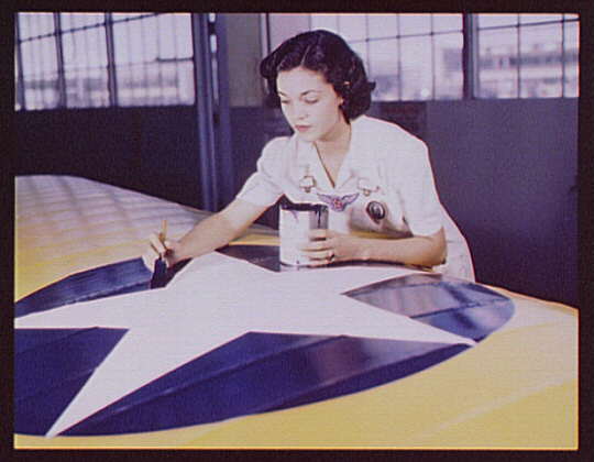 Painting insignia on airplane wings (Library of Congress)